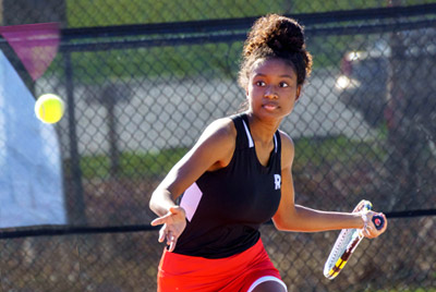 Tennis player getting ready to hit the ball.